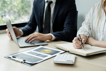 Two business leaders talk about charts, financial graphs showing results are analyzing and calculating planning strategies, business success building processes