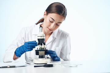 woman laboratory assistant microscope microbiology research