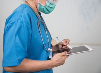 Medicine doctor/Nures working with her digital tablet in the hospital. medical staff in uniform