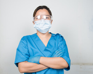 Medical Doctor/Nures in uniform ware protection equipment from pathogen. Medical staff in isolated background in hospital.