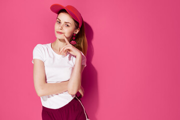 cheerful woman in red cap summer fashion clothes posing pink background