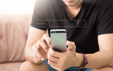 man using smart phone while relaxing on sofa. Concept of young business people working at home