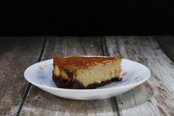 Traditional cheese cake serving on the plate. Famous sweet dessert in Asia restaurant. 