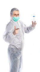 a man in a white protective suit holds a large syringe and points a finger at us. vaccination. isolated white background