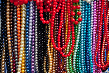 Necklace of colorful stones on the table. Many different jewelry and beads made of natural precious minerals. Beaded jewelry is on sale at the fair.