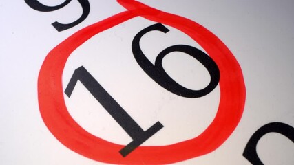 16 - Marking the date in the calendar with a red marker. The sixteenth day of the month. A time limit or deadline is a narrow field of time, or a particular point in time