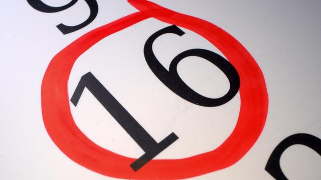 16 - Marking the date in the calendar with a red marker. The sixteenth day of the month. A time limit or deadline is a narrow field of time, or a particular point in time