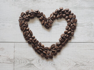 Coffee heart image copy space on white wood table top view and nature light and shadow cafe concept