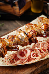 Caucasian chicken wings shashlyq skewers on a wooden background
