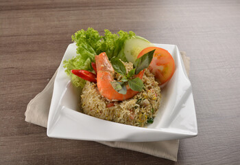 stir fried egg rice with seafood tiger prawn in thai green curry sauce in wood background asian halal menu