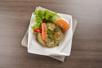 stir fried egg rice with seafood tiger prawn in thai green curry sauce in wood background asian halal menu