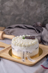 Chiffon coconut cake decorated with rosemary and chocolate for birthday cake on wooden board, Thai style.