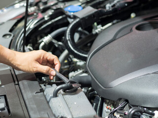 Fototapeta na wymiar Hand checking equipment interior engine of car