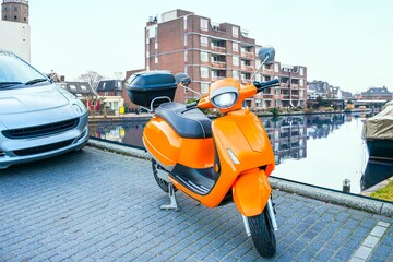orange-colored scooter amid cloudy Holland