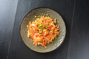 thai style spicy chilli tom yum dry fried egg rice with seafood prawn and meat in black background asian halal menu