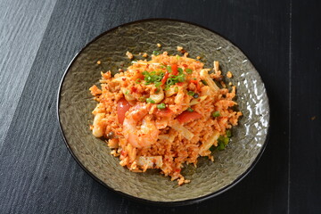 thai style spicy chilli tom yum dry fried egg rice with seafood prawn and meat in black background asian halal menu
