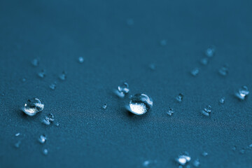 Water drops on a blue horizontal background.