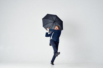 man in suit with umbrella weather protection from rain