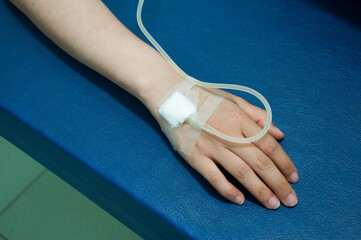 Close up of iv drip in patient's hand. Medical doctor provide intravenous fluid at the bed side in the hospital. medical treatment.