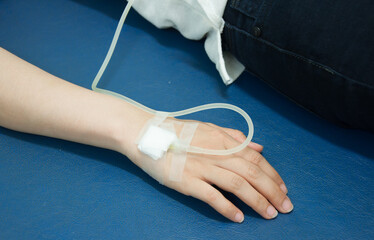 Close up of iv drip in patient's hand. Medical doctor provide intravenous fluid at the bed side in the hospital. medical treatment.