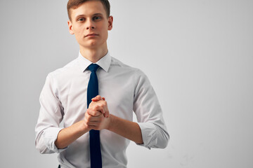 man in white shirt with tie gesturing with hands success emotions self-confidence
