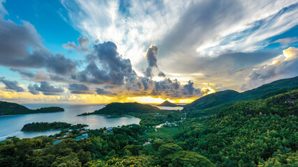 Mahe Island coast high resolution drone panorama during sunset, with dramatic sky, clouds, lush...