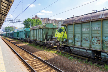 Fototapeta na wymiar Old railway wagons await unloading on the platform of Pavshino station. Moscow Region, Russia