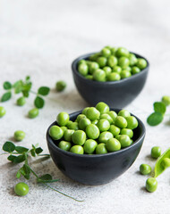 Fresh green peas pods and green peas with sprouts on concrete background.