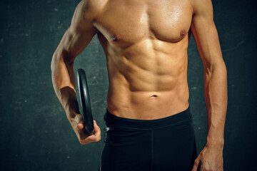 athletic man with pumped up abs workout motivation posing