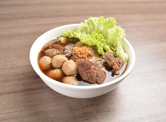 Vietnamese braised beef meat ball hot soup bowl in wood background asian halal menu