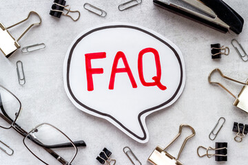 Word faq frequently asked questions with stationery on working place