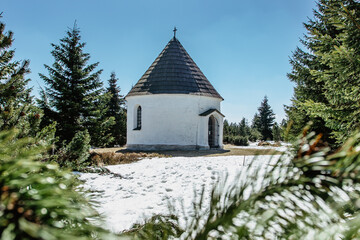 Baroque Chapel of the Visitation of the Virgin Mary,Kunstat Chapel, located in Eagle Mountains at altitude of 1035 m, Czech Republic.Circular floor plan and roof covered with shingles.Sunny day