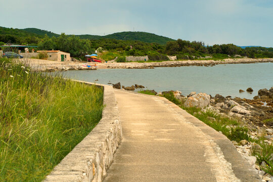 Old town of Osor and beautiful Adriatic sea coast on a cloudy day on Croatia islands Cres and Losinj