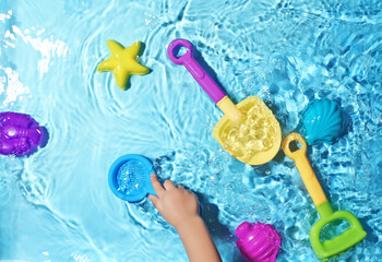 Children's fun with beach toys on splashing water