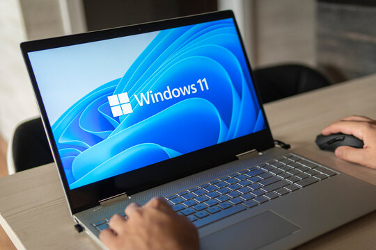 Windows 11 logo on laptop screen. A new operating system update from Microsoft