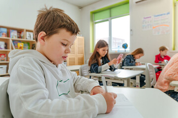 Fototapeta premium Elementary school students learning in the classroom