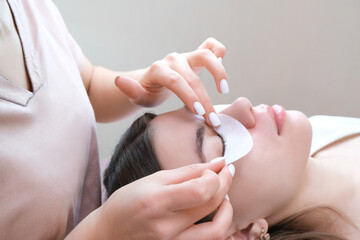 Young woman doing eyelash lamination procedure