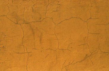 Yellow plaster texture background. Abstract grunge decorative dark yellow stucco wall background. Art rough ocher cracked texture backdrop with copy space. Cement ocher plaster wall have rough surface