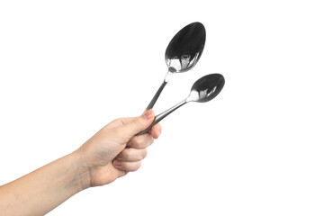 Two different steel spoon in woman hand, isolated on a white background photo