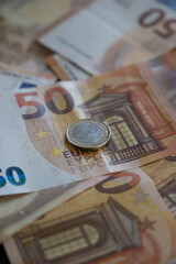 50 euro banknotes money and 1 euro coin