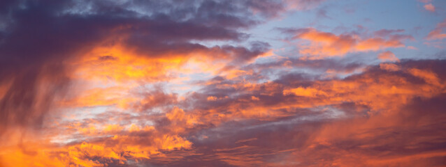 Beautiful epic orange dark blue sunset sky. Wide picture
