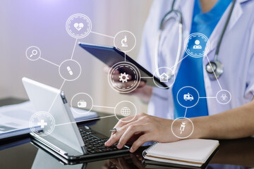 Medical technology concept. Doctor working with mobile phone and stethoscope and digital tablet laptop in modern office at hospital