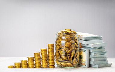 Savings growth or successful investment. Pile of gold coins with steps and glass jar full of coins....