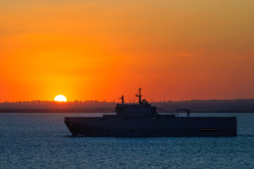 navy ship at sunset