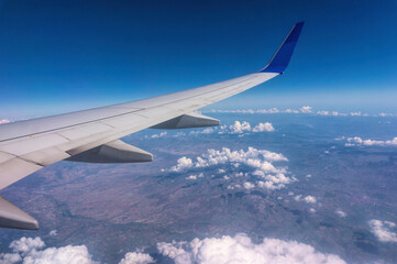 Wing of a passenger plane and the sky overboar. Summer trip	