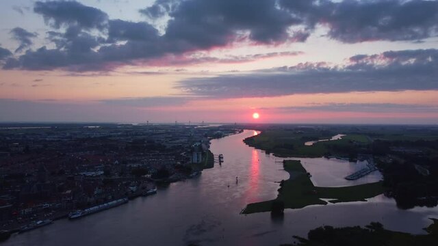 Evening drone view over the river Ijssel and the skyline of Kampen in Overijssel during summer