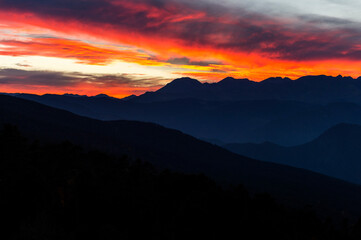 colorful sky at sunset behind the mountains with different shades