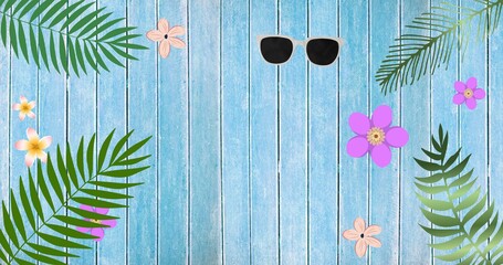 Composition of exotic leaves, sunglasses and flowers with copy space on wooden background