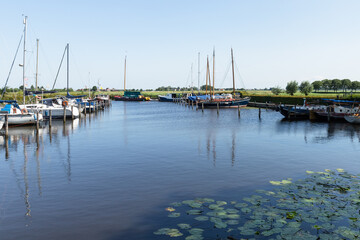 Fototapeta na wymiar Sailboats in a small marina surrounded by farmlands.