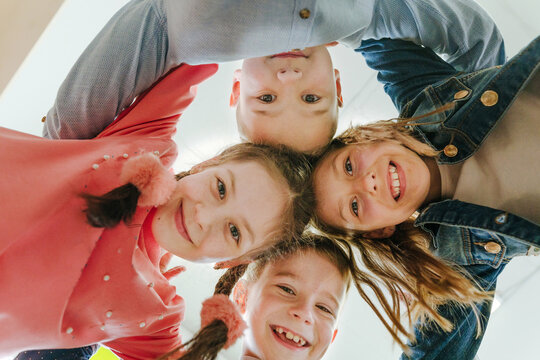 Group of children looking at camera laughing and smiling
